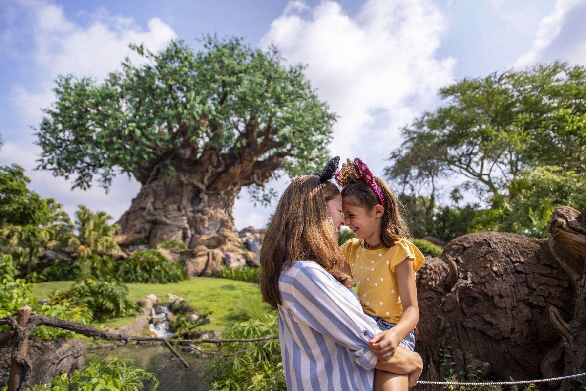 A mother and daughter share a moment near the Tree of Life at Disney's Animal Kingdom Theme Park, Walt Disney World Resort.