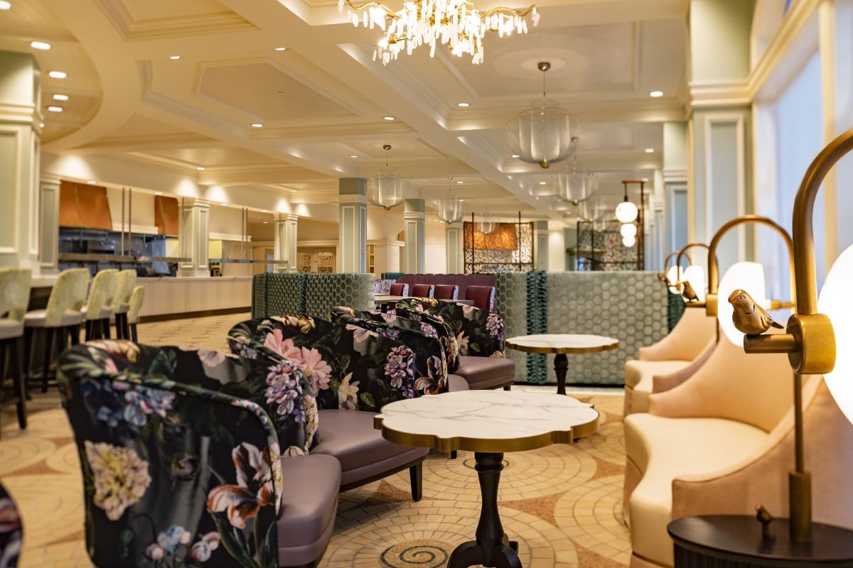 Elegant dining room at Citricos inside Disney's Grand Floridian Resort, with plush seating, chandeliers, and warm lighting set for an upscale table service meal.