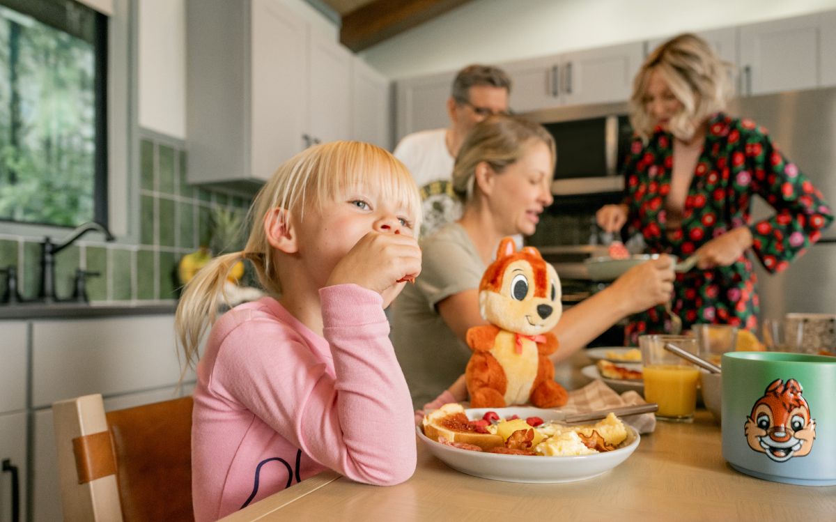 A child standing at the full-size kitchen inside a cabin at Disney's Fort Wilderness Resort & Campground at Walt Disney World Resort.