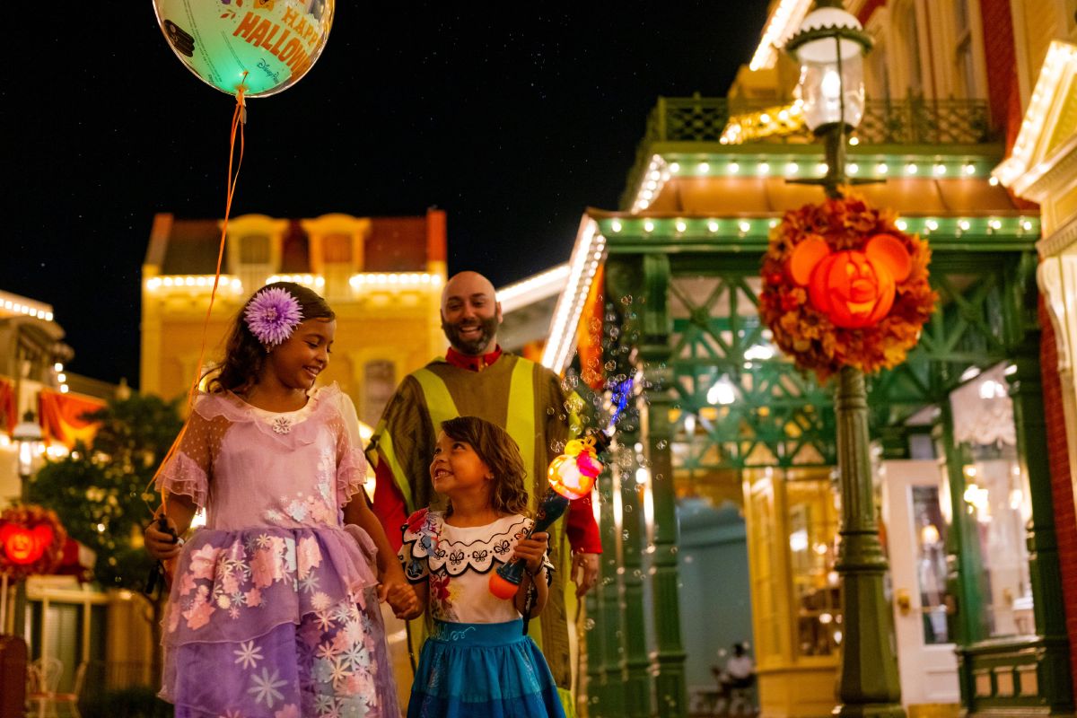 A family in Halloween costumes walks down Main Street, U.S.A., during Mickey's Not-So-Scary Halloween Party at Magic Kingdom Park.