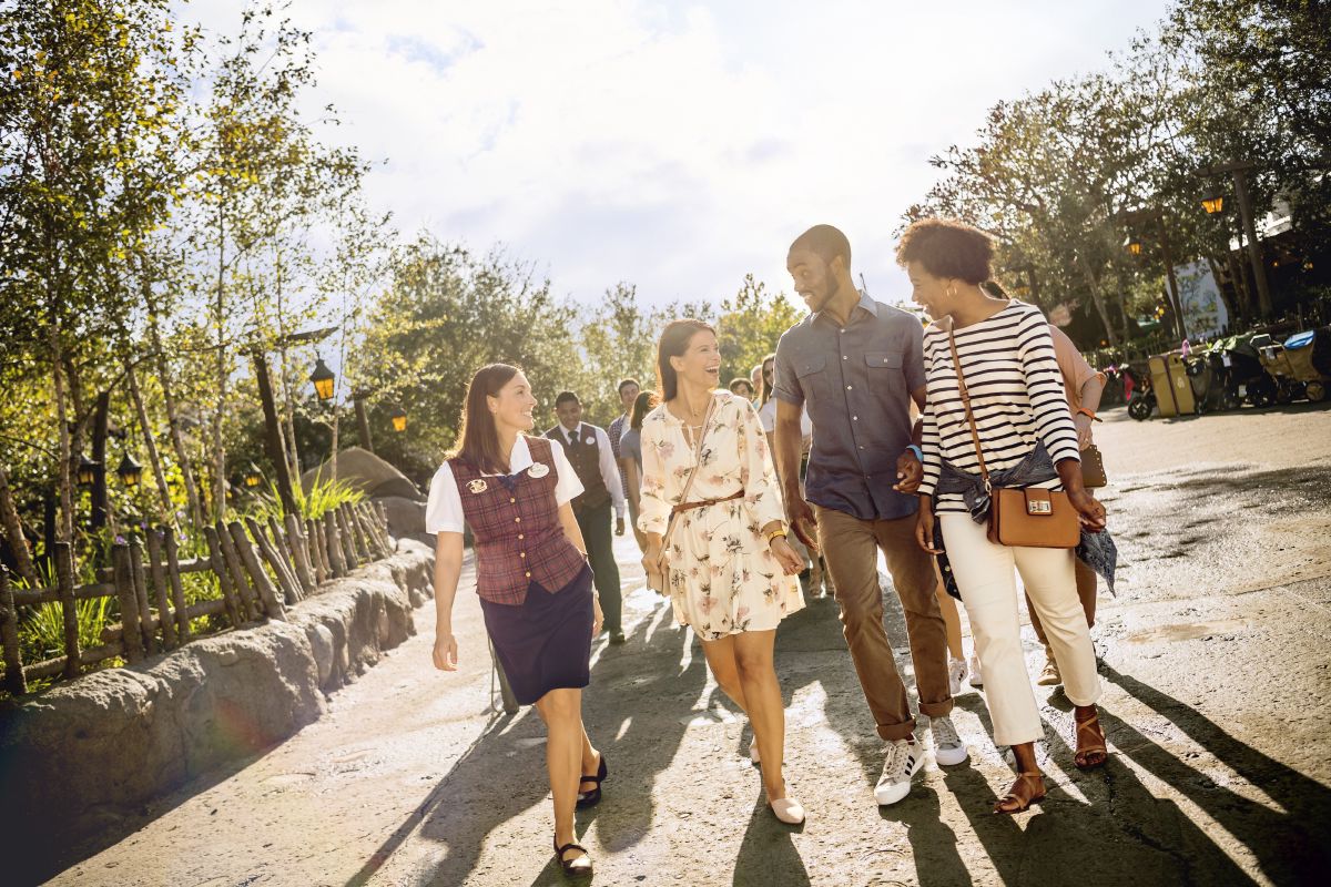 A family walking with a VIP tour guide through Adventureland at Magic Kingdom Park, Walt Disney World Resort.