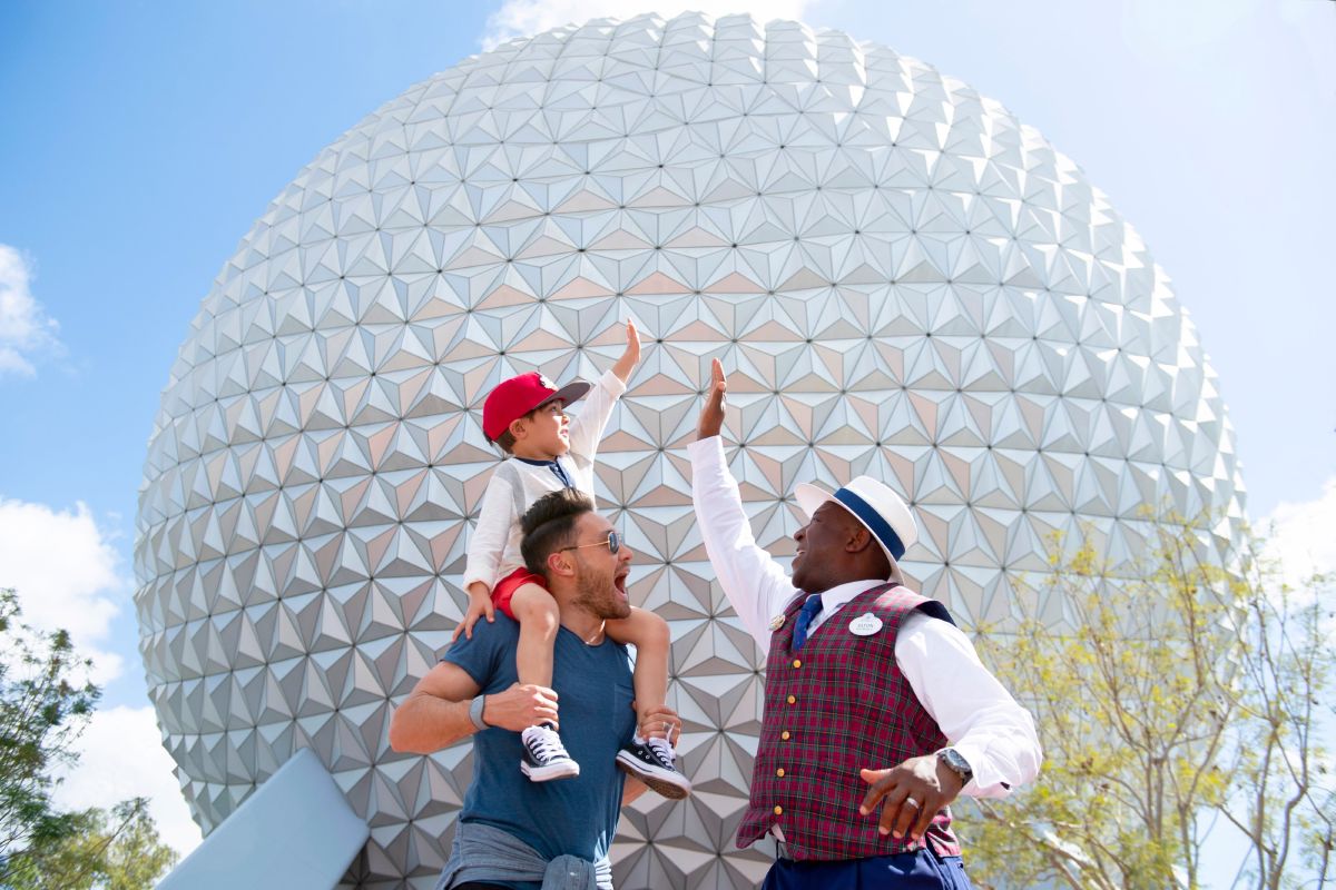 A family with a VIP tour guide standing near Spaceship Earth at EPCOT, Walt Disney World Resort.